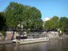 Banks of the Seine river - Docked houseboat on Quai de Montebello