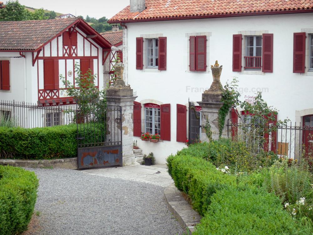 La Bastide-Clairence - Basque Country: garden of the church and white houses with red shutters in the Navarre fortified town
