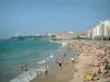 Biarritz - Grande Plage beach and tourists, waterfront of the resort, lighthouse of the Saint-Martin headland and the Atlantic Ocean