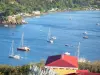 Bouillante - View of the Caribbean sea, boats floating on the water and houses along the Galets cove