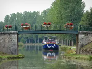 Burgundy Canal - Flower-bedecked bridge spanning the canal and moored barge