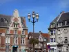 Cambrai - Lamppost decorated with flowers and houses of the city