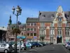 Cambrai - Houses, shops, tower of the Saint-Géry church, lamppost decorated with flowers