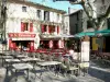 Carcassonne - Facades of houses and café terraces of the Place Marcou square