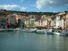 Cassis - Houses in colourful facades lining the port and its boats