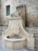 Castillon-du-Gard - Fountain topped by a lion statue and a facade of a stone house