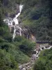 Cauterets waterfalls - Lutour waterfall surrounded by trees and footbridge spanning the rocks