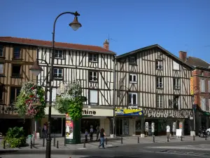 Châlons-en-Champagne - République square: timber-framed houses, shops, lamppost decorated with flowers