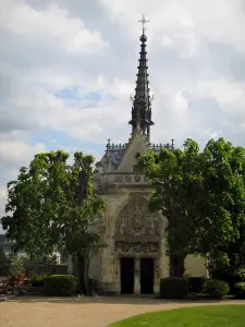 Château d'Amboise - Saint-Hubert chapel of Flamboyant Gothic style and trees, clouds in the sky
