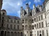 Château de Chambord - Renaissance Château: watch tower of the keep and galleries, clouds in the blue sky