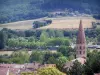 Cluny - Bell tower of the Saint-Marcel church, roofs of houses, fields and trees