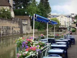 Dole - Café de la terraza a la orilla del agua, barandas decoradas con flores, el canal de Tanner, casas y edificios en la ciudad