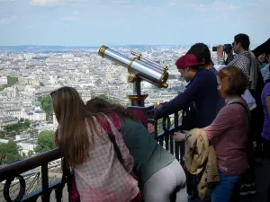 Eiffel tower - Visitors on the second floor admiring the view over Paris