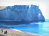 Étretat - Pebble beach with walkers, the Channel (sea) and the Aval cliff (chalk cliff) with its arc (the Aval gateway)
