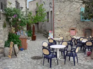 Eus - Café terrace and stone houses of the village