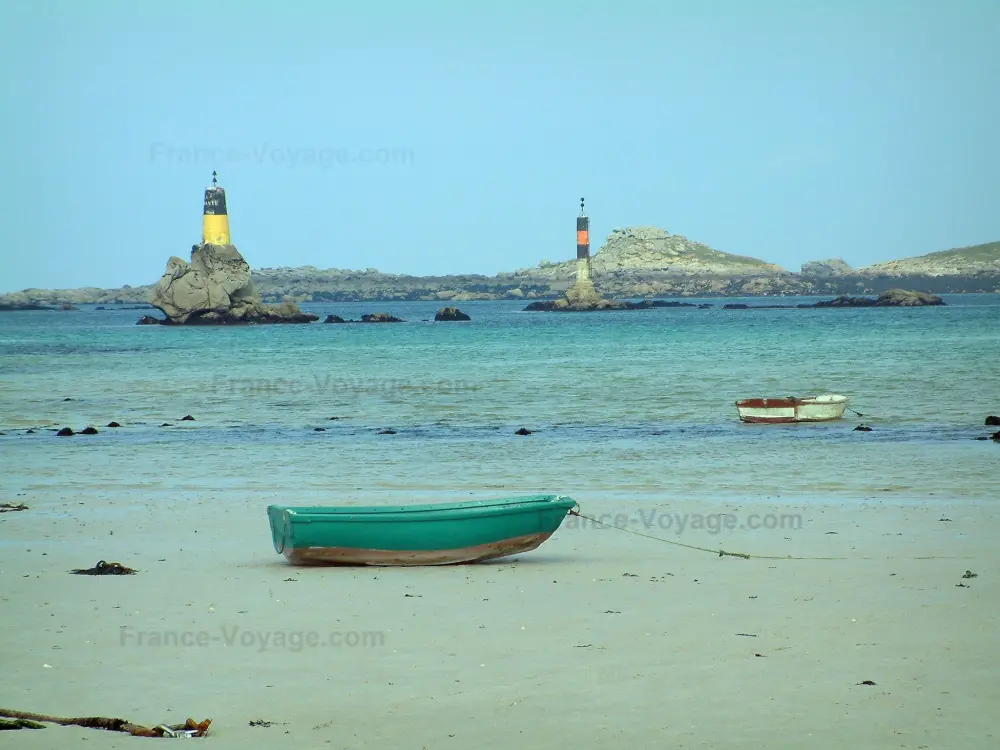 Guide of the Finistère - Landscapes of the Brittany coast - Sandy beach with a small colourful boat, sea, lighthouses, and coasts far off