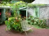 Folio house - Outbuildings, wrought iron bench and flowering plants