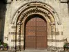 Fresnay-sur-Sarthe - Portal of the Notre-Dame Romanesque church with its carved oak door