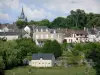 Fresnay-sur-Sarthe - Bell tower of the Notre-Dame church, facades of houses, and greenery