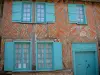 Gerberoy - House facade with bricks, half-timberings and blue shutters