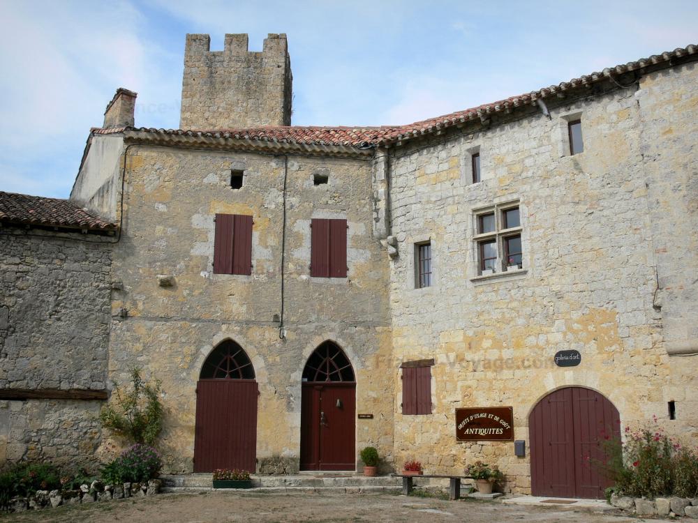 Guide du Gers - Larressingle - Tour crénelée et façades de maisons du village médiéval fortifié
