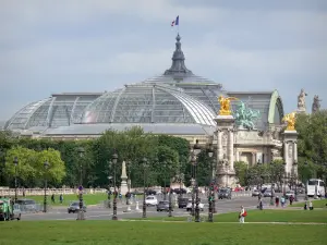 Grand Palais palace - View on the glass roof of the Great Palace and the sculptures of the Pont Alexandre-III bridge from the Invalides esplanade