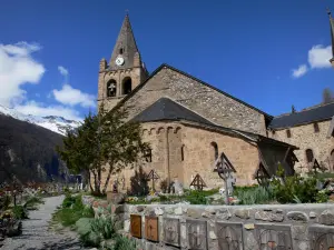 La Grave - Notre-Dame-de-l'Assomption church of Romanesque style and cemetery of the village, mountain in background