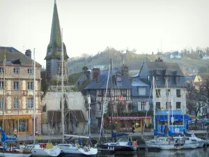 Honfleur - Sailboats in the Vieux Basin pond (port), Saint-Etienne church home to the navy museum, and houses of the Saint-Etienne quay