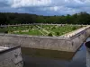 Guide of the Indre-et-Loire - Château de Chenonceau - Diane de Poitiers garden with its fountain, its shrubs and its formal flowerbeds, moats, trees and clouds in the sky