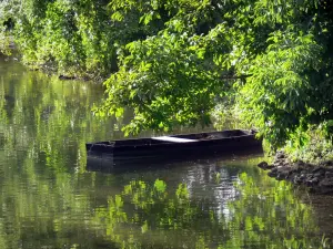 Indre valley - Boat on water and trees reflecting in the river Indre