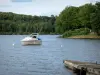 Landscapes of Burgundy - Settons lake (artificial lake), in the Morvan Regional Nature Park: boat on the lake and wooded banks