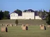 Landscapes of the Gironde - Château Phélan Ségur, winery in Saint-Estèphe in the Médoc, and bales of hay in the foreground 