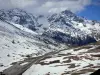 Landscapes of the Hautes-Alpes - Road leading to the Col du Lautaret pass and mountains dotted with snow; in the Écrins National Nature Park