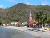 Landscapes of Martinique - Fishing village of Anse d'Arlet at the edge of the Caribbean Sea, with its church steeple, its houses and its sandy beach
