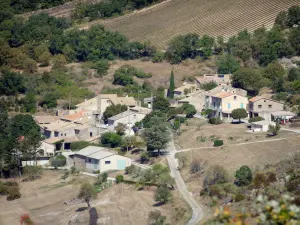 Landschaften der Drôme - Regionaler Naturpark Baronnies Provençales: Blick auf die von Bäumen umgebenen Häuser von La Bâtie-Verdun