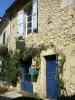 Lavardens - Facade of a stone house with blue doors 