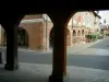 Lisle-sur-Tarn - From the arches in the fortified town, view of the main square (arcaded square) and its brick-built houses