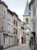 Massiac - Narrow street lined with houses, overlooking the bell tower of the Saint-André church