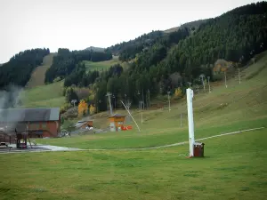 Méribel - Ski resort (winter sports) with ski lift (chairlift) of the ski area and spruces