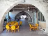 Monflanquin - Medieval bastide town: sidewalk café under the arcades