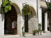 Monflanquin - Medieval bastide town: flower-bedecked arcades of the central square