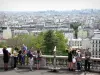 Montmartre - Terrace of the Louise Michel square, below the Sacred Heart basilica, with its view over the city of Paris