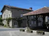 Mortemart - Wooden hall and flower-decked houses of the village