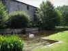 Mortemart - Castle of the Dukes, moats with a swan, plants and trees