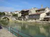 Nérac - Quays, Baïse river, old Bridge, houses of the medieval town and bell tower of the Notre-Dame church overlooking the place, in the Pays d'Albret region
