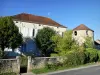 Noyers - Facade of a stone house and remains of the fortifications of the medieval village