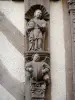 Noyers - Sculpted figures adorning the facade of a half-timbered house