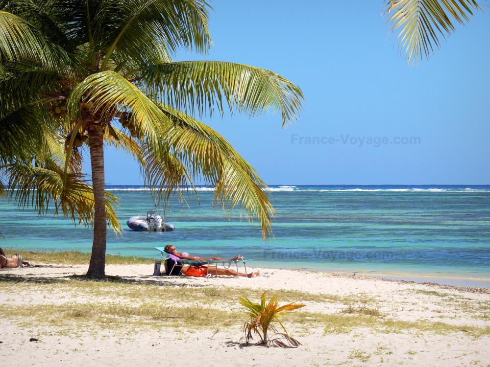 Guide d'Outre-Mer - Marie-Galante - Détente sur la plage de Grand-Bourg, avec son sable blanc, ses palmiers et son lagon