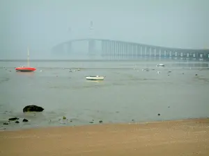 Paisagens do litoral Loire-Atlantique - Barcos na maré baixa e ponte de Saint-Nazaire