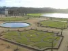 Park of the Palace of Versailles - Orangery in winter (flowerbeds and water basin) and Swiss pond